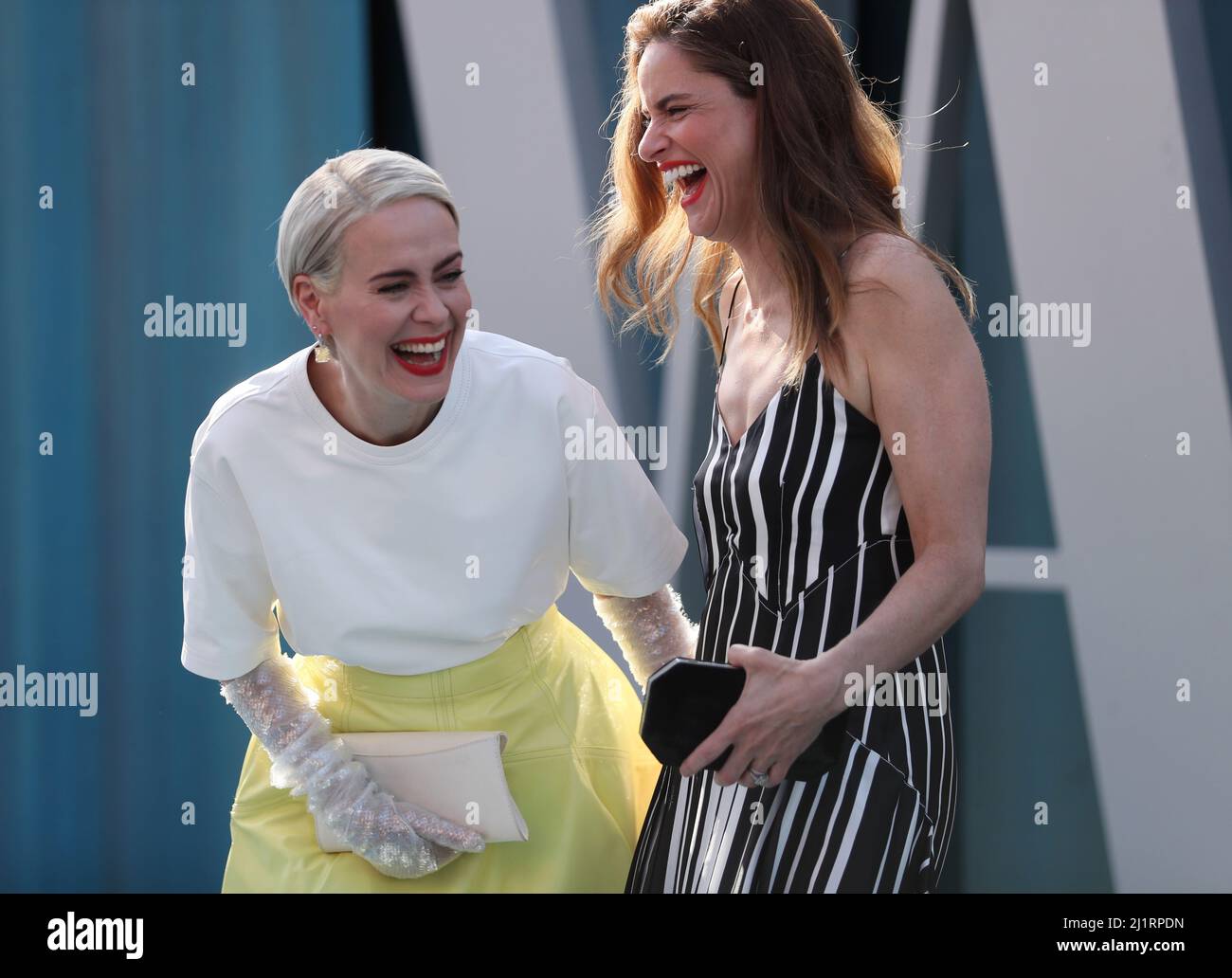 Sara Paulson (L) and Amanda Peet share a light moment as they arrive at the Vanity Fair Oscar party during the 94th Academy Awards in Beverly Hills, California, U.S., March 27, 2022.  REUTERS/Danny Moloshok Stock Photo