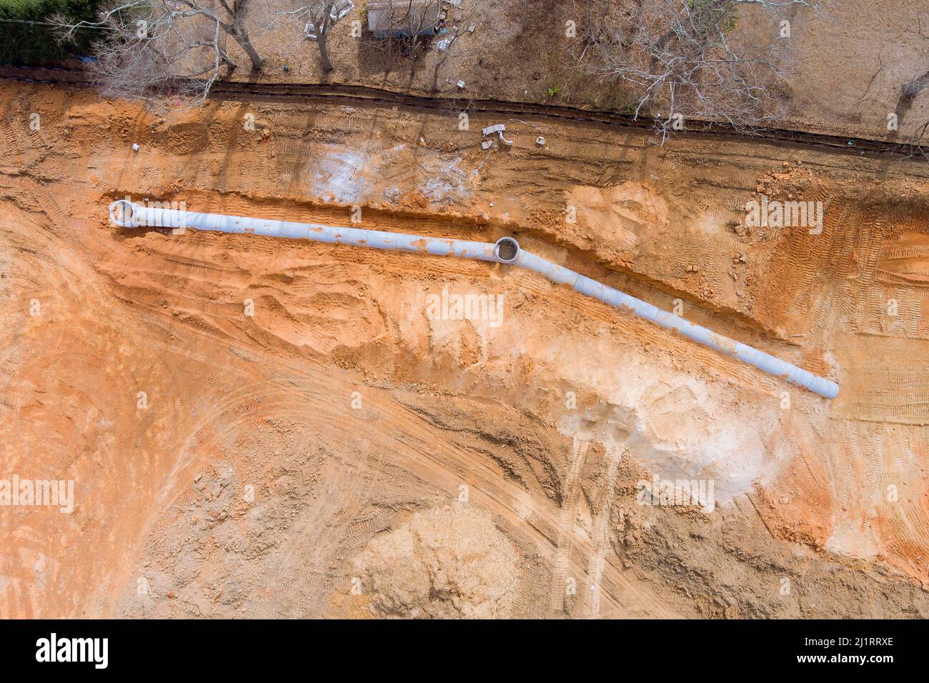 Aerial top layer pipes installation of underground utilities on