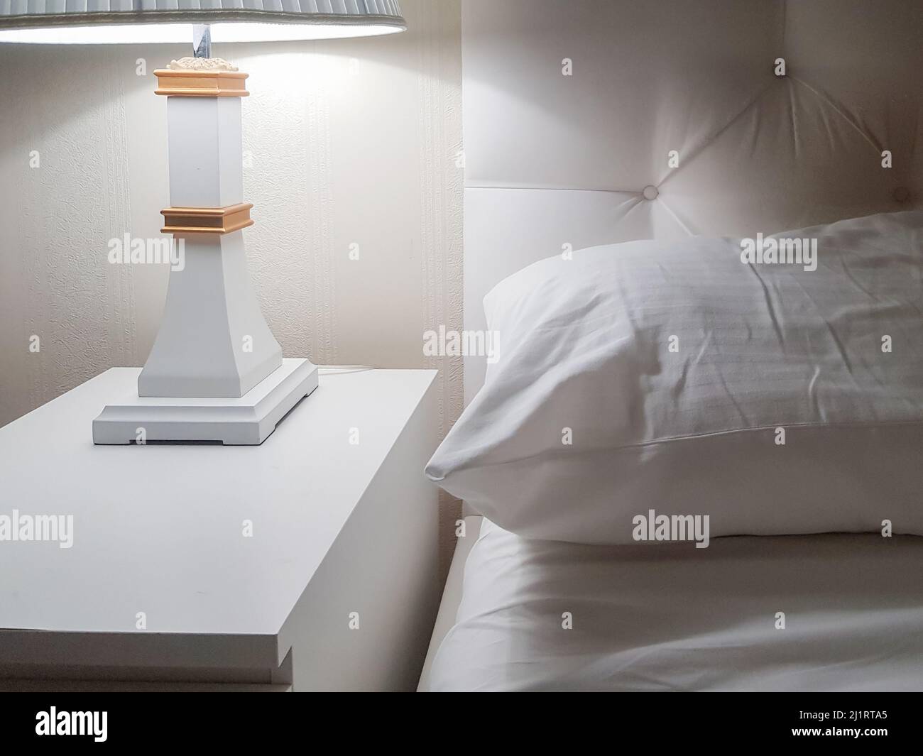 Luxury modern design of a bright bedroom with a bedside table and a ...