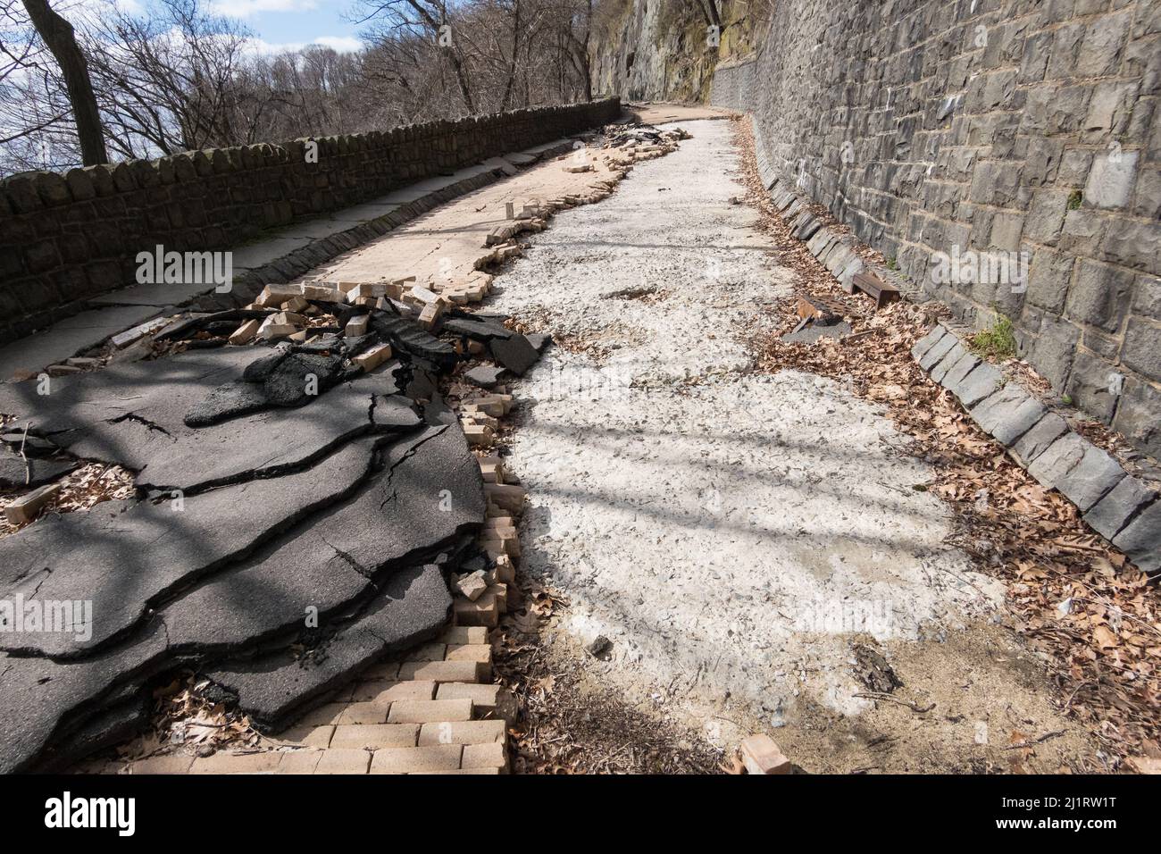 Aftermath of the hurricane, tropical storm Ida - damaged pavement on Dyckman Hill Road, Englewood Cliffs entrance to the Palisades Interstate Park, NJ Stock Photo
