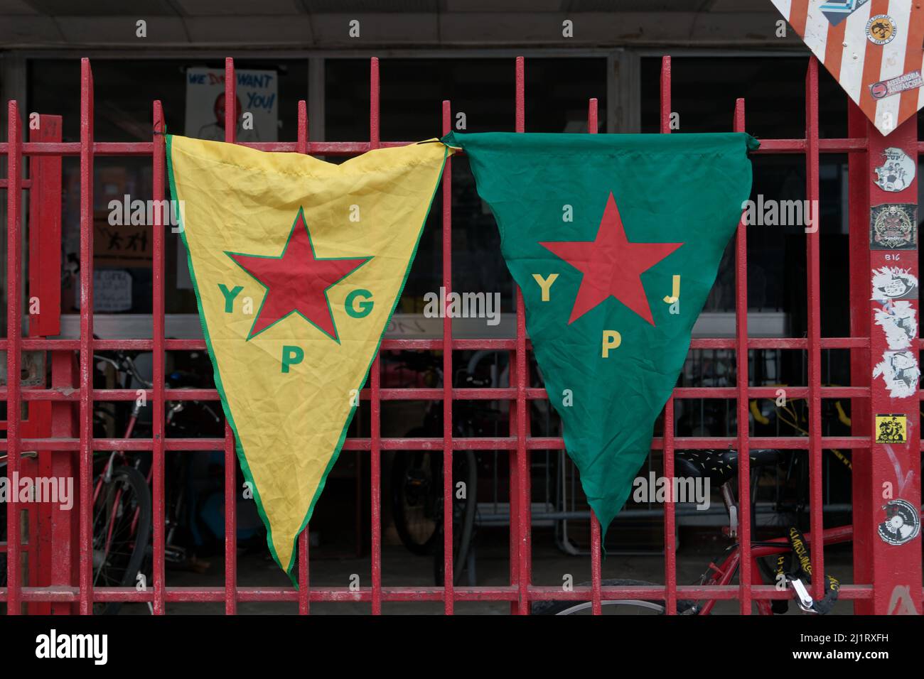 Turin, Italy. 27th Mar, 2022. YPG (People's Defense Units, left) and YPJ (Women's Defense Units, right) flags exposed at the celebration of the Newroz, the Kurdish New Year. Credit: MLBARIONA/Alamy Live News Stock Photo