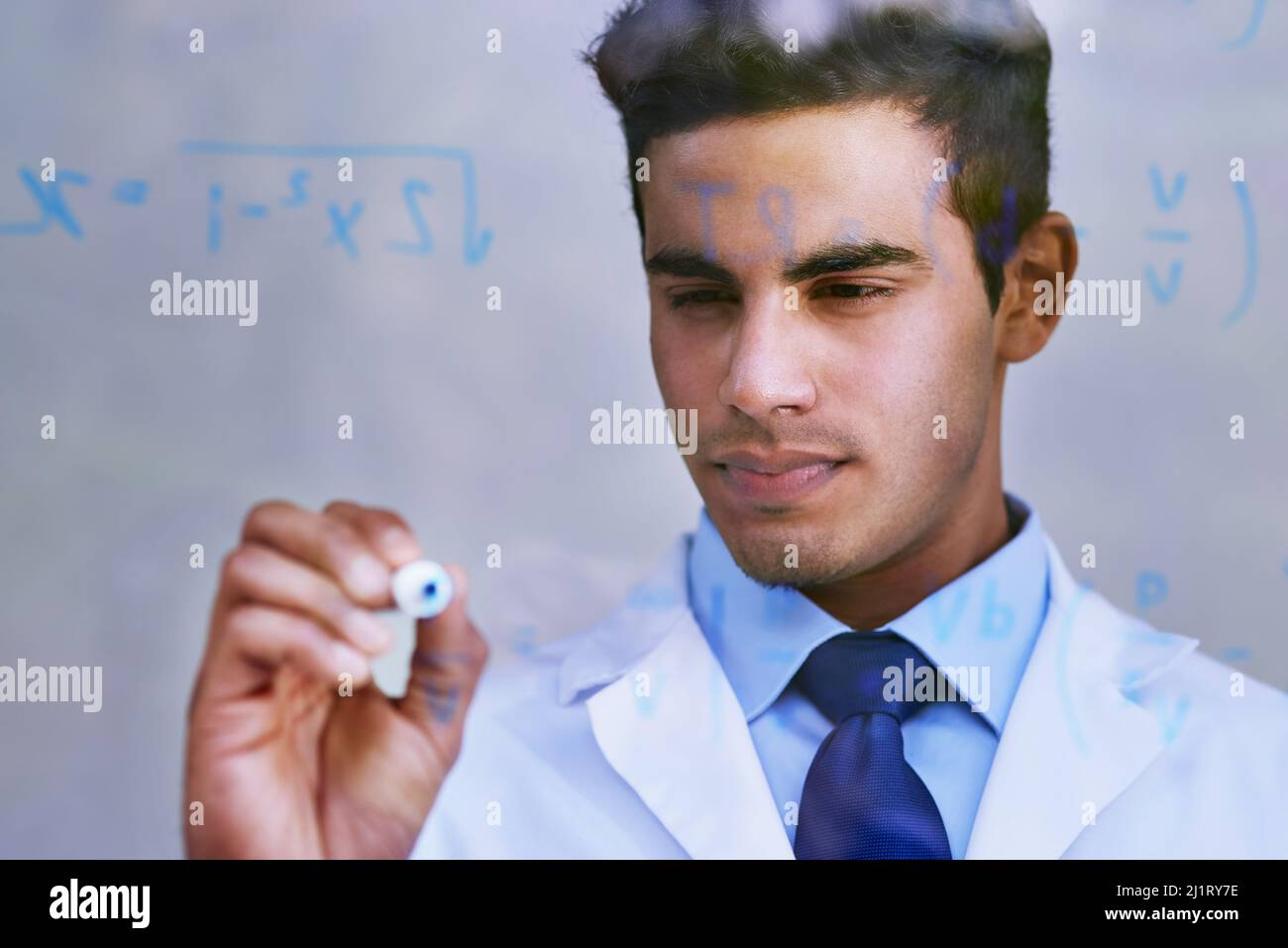 Formulating a new hypothesiss. Shot of a scientist writing formulas on