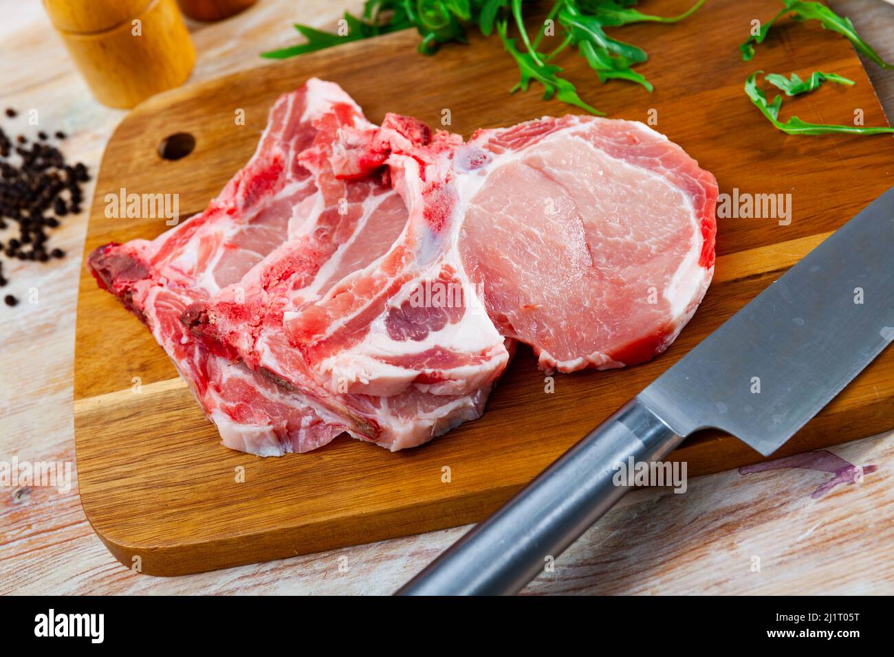 Fresh raw pork loin chops with condiments Stock Photo Alamy