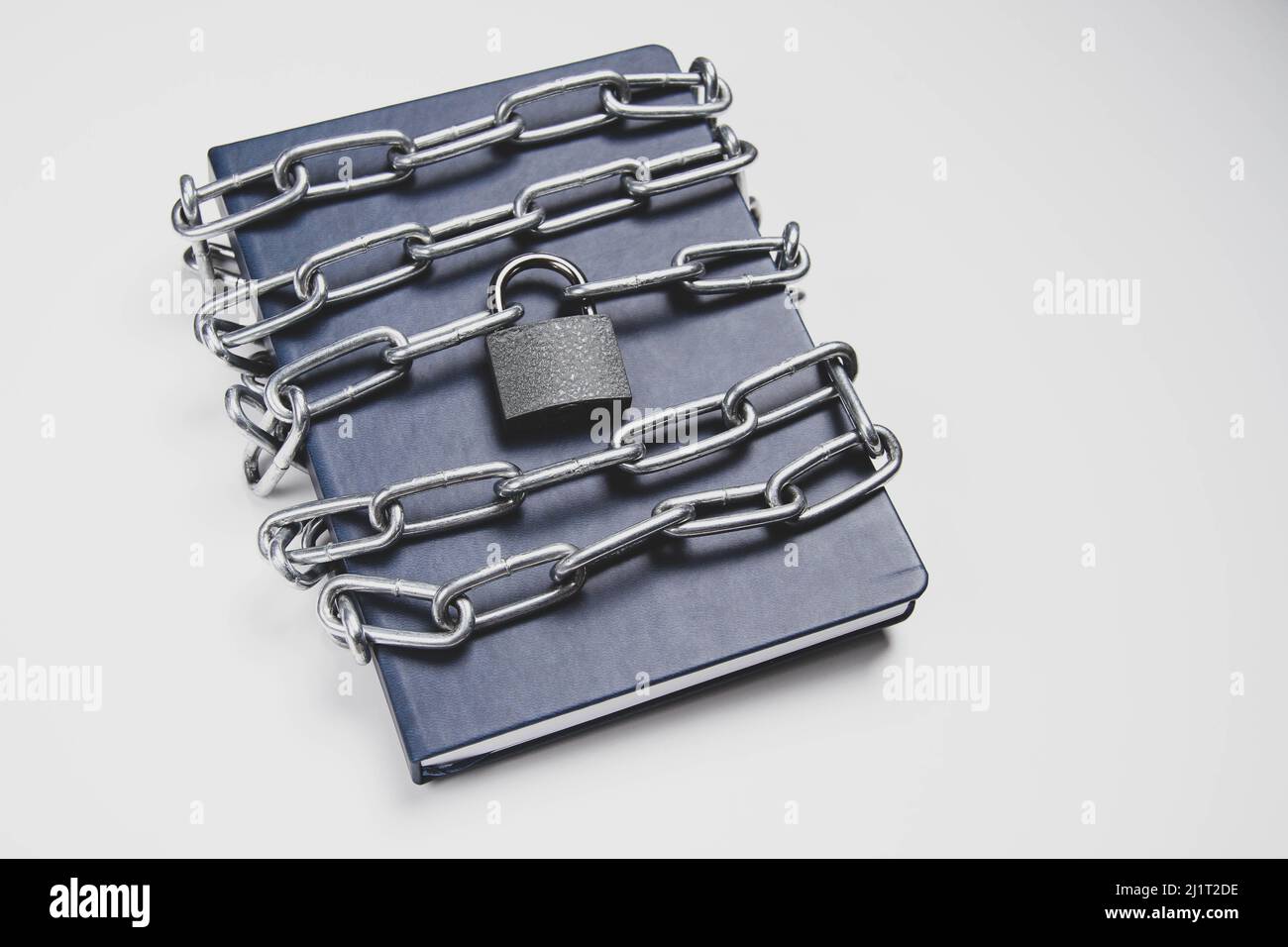 The book is locked under lock and key on a white background. Secret ...