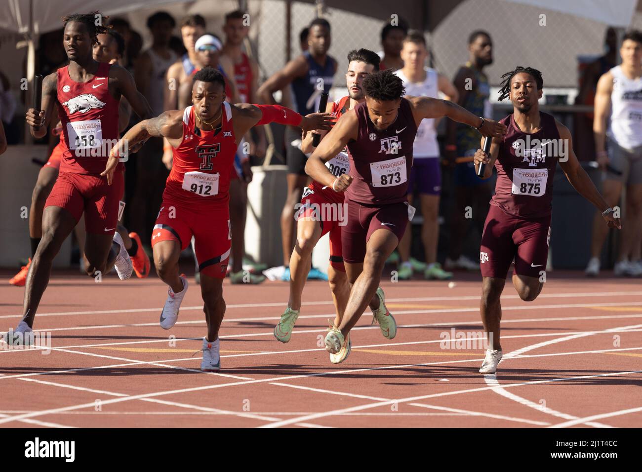 Texas Tech and Texas A&M on the final exchange of the 4 x 100 during