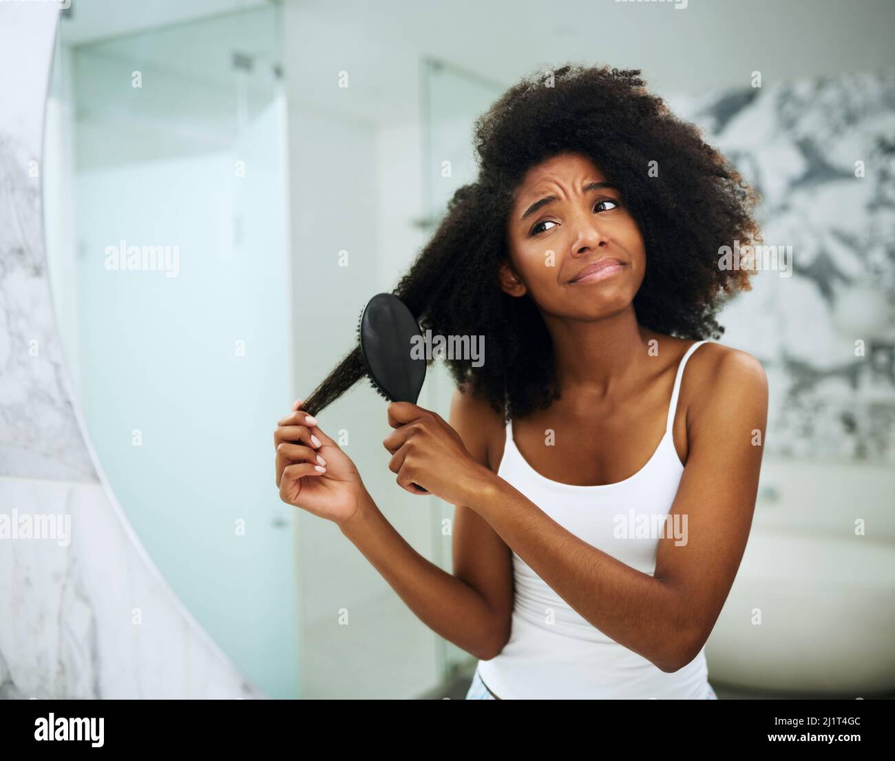 Struggle with dry, brittle hair. Shot of an attractive young woman