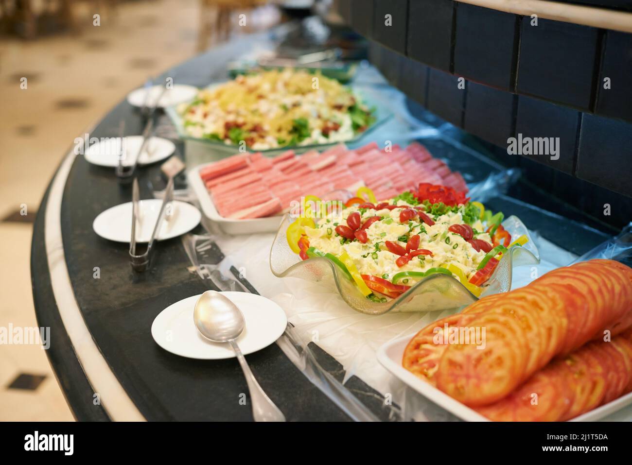 Pick your dish. A selection of dishes on a rotating buffet counter. Stock Photo