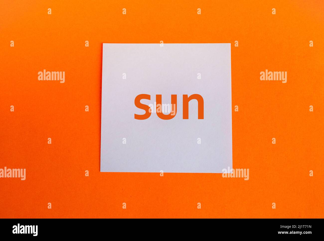 White paper square on an orange background with the hashtag sun in