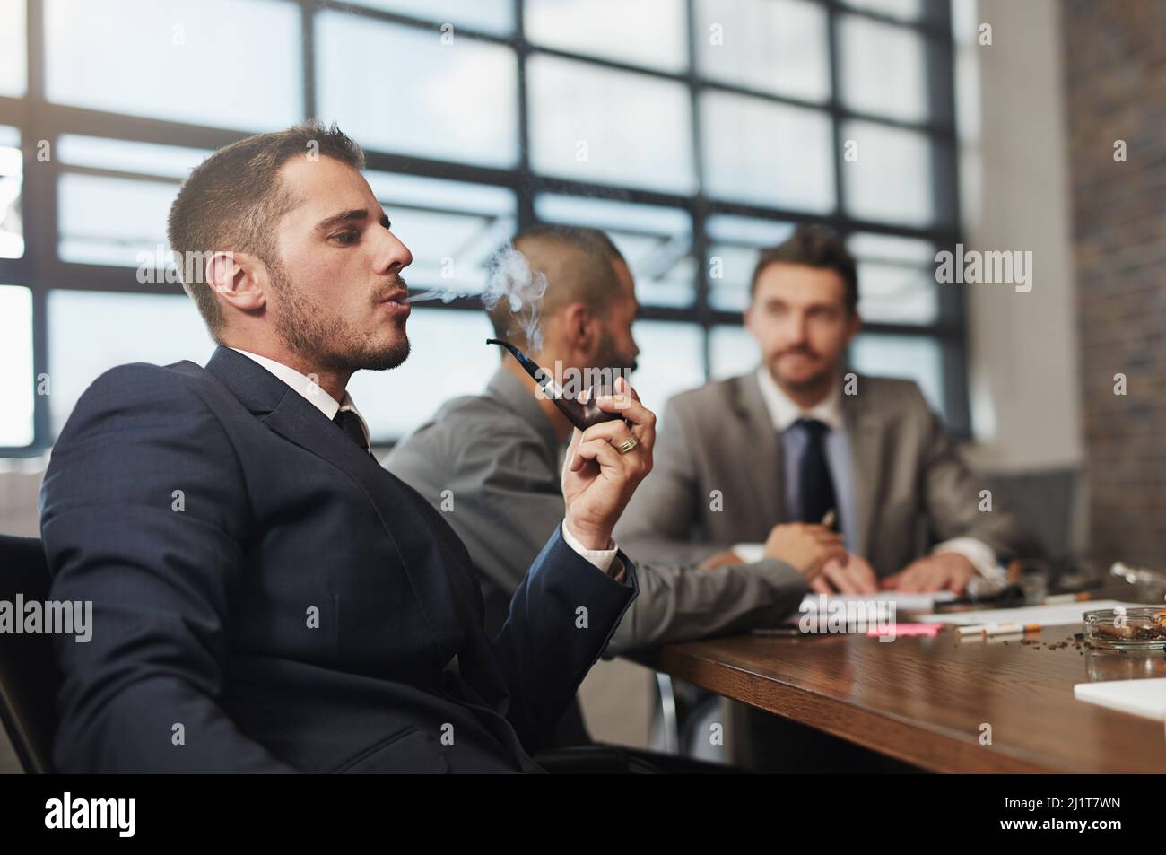 Taking a break from the brainstorming. Shot of a businessman smoking a