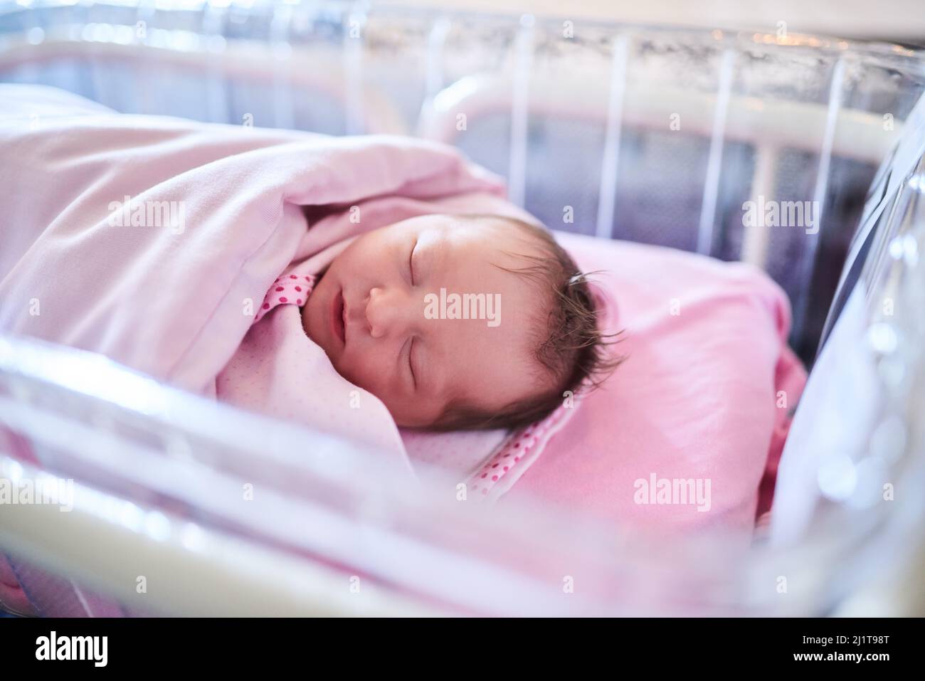 We hope all her dreams come true. Shot of a newly born baby girl wrapped in a blanket in the hospital. Stock Photo