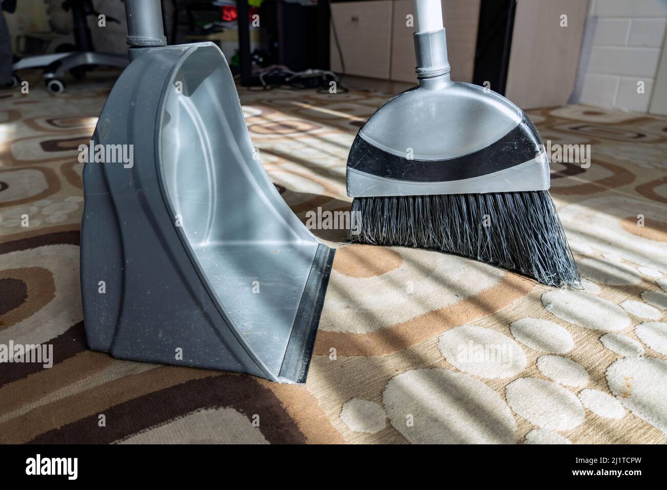 Cleaning.Clean up the garbage from the floor with a broom for