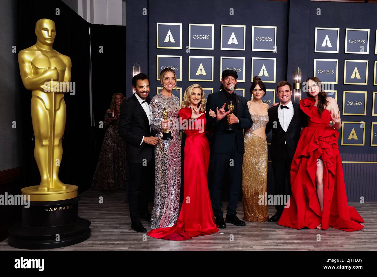 The cast and crew pose with their Oscars for Best Picture for "CODA" in the photo room during