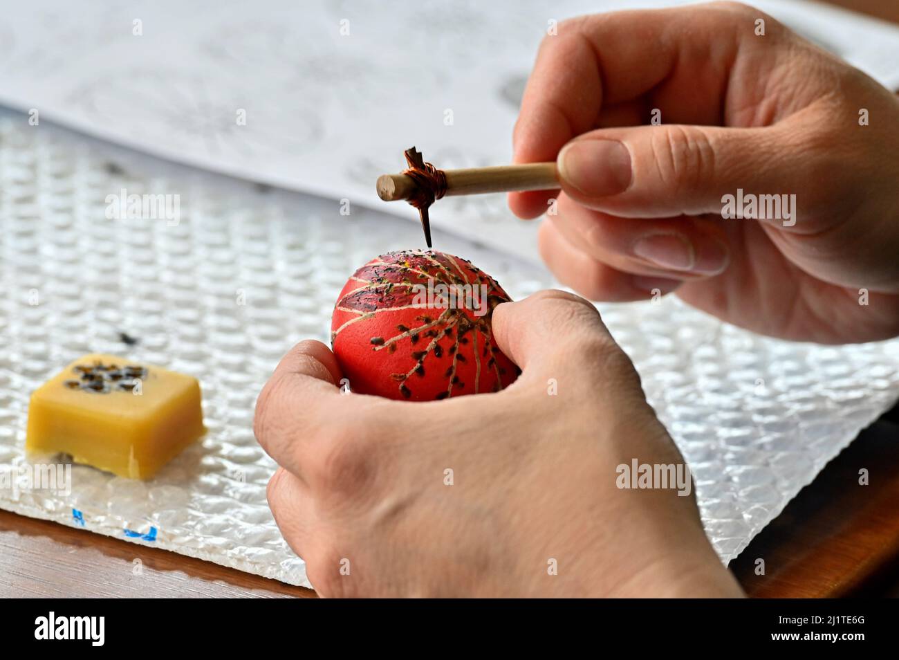 Olyphant, United States. 27th Mar, 2022. A woman places wax on a hollowed out egg that is then dipped in different eggs to make a Ukrainian Easter Egg. Pysanky is the art of writing with wax on hollowed eggs to make Ukrainian Easter Eggs. A class was held to teach Pysanky and funds were collected to be sent to Ukraine. Credit: SOPA Images Limited/Alamy Live News Stock Photo