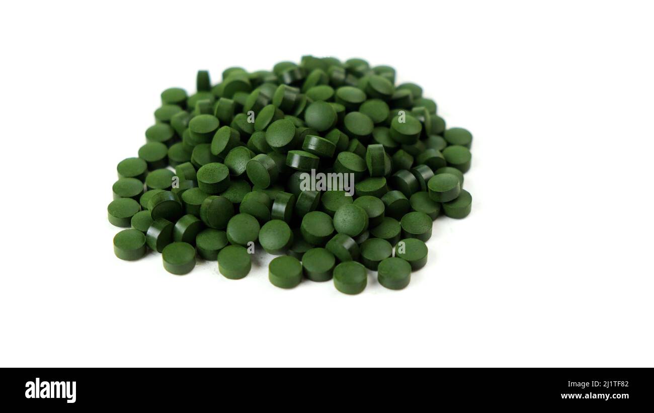Spirulina algae tablets isolated on white background. Nutritional