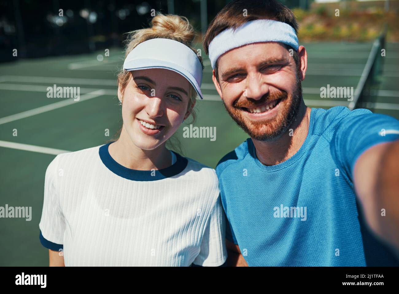 We found love on the tennis court. Portrait of a happy young couple taking  selfies while playing tennis together outdoors on the court Stock Photo -  Alamy