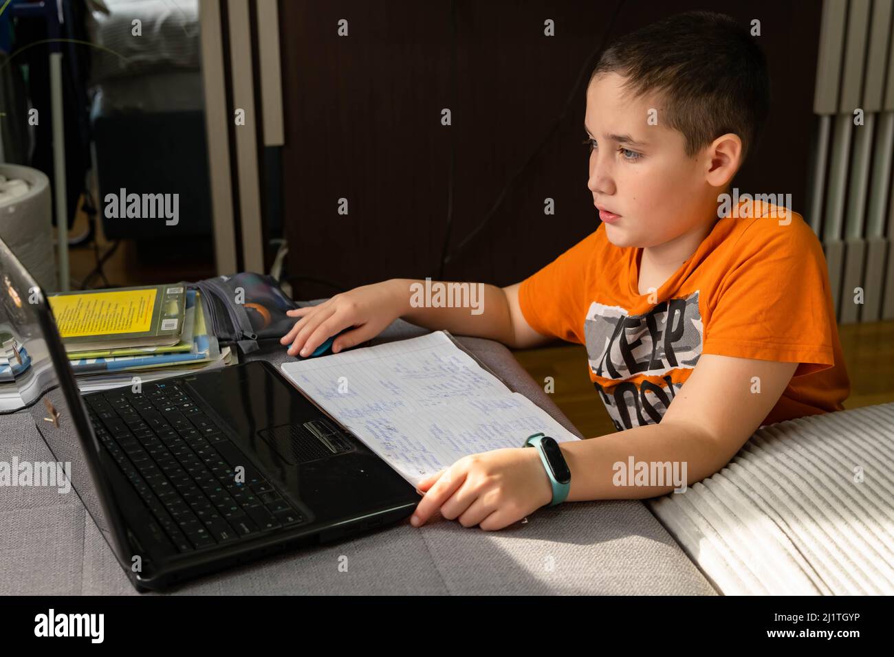 Kid self isolation using tablet for his homework. Online education Stock Photo