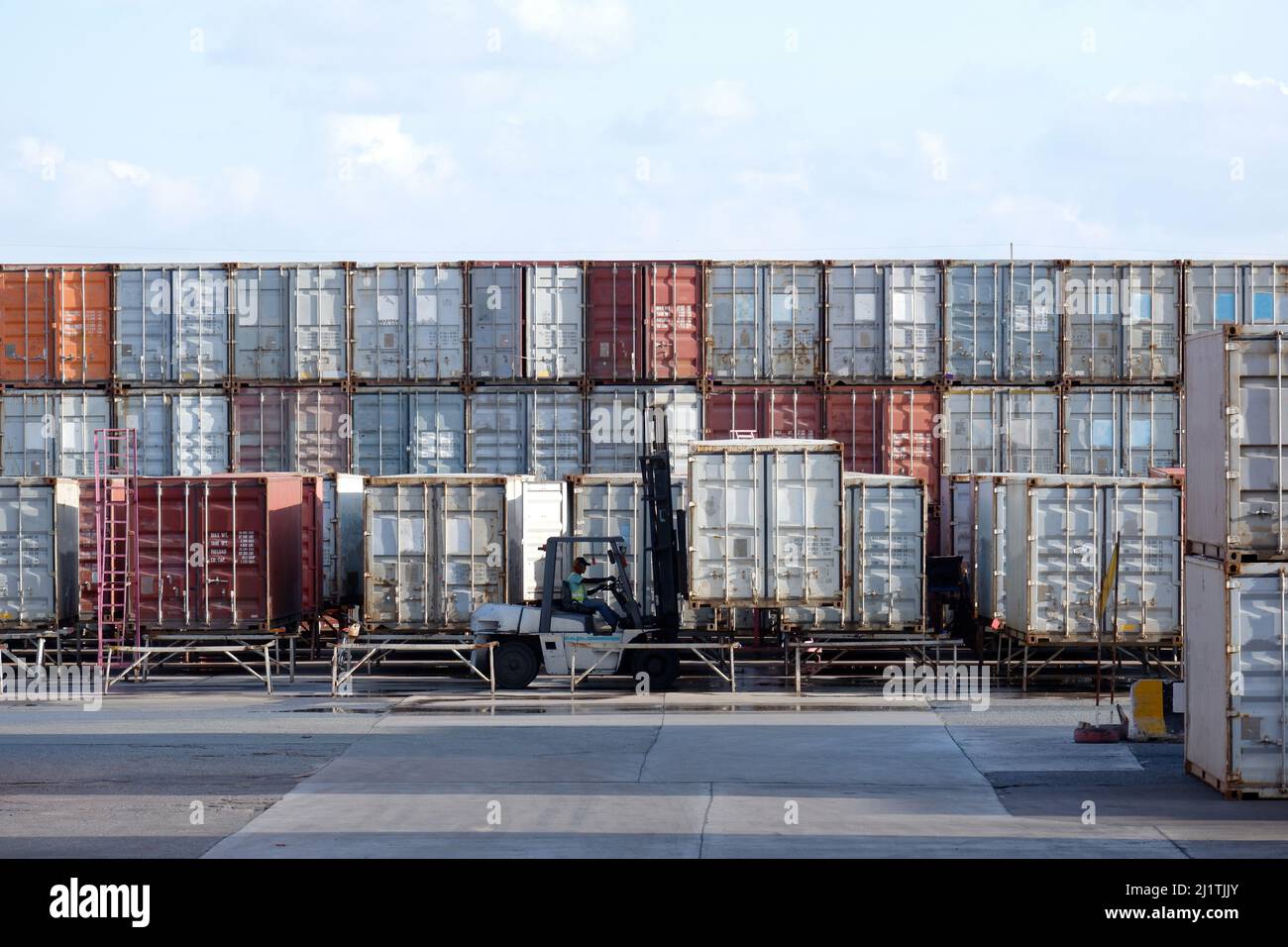 Industrial logistics transport forklift truck transport container box loading stacker at port to truck for shipping export and import trade goods at p Stock Photo
