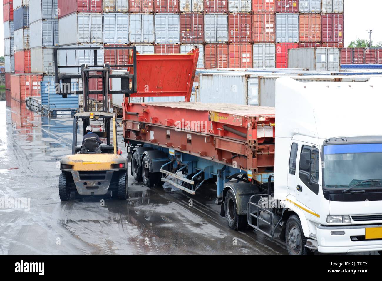 Boxed tractor forklifts are loaded into cargo containers that Port