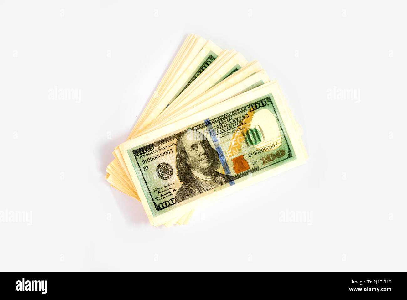 stack of us one hundred dollar paper currency isolated on white background Stock Photo