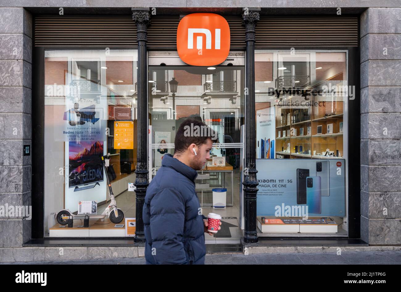A pedestrian walks past the Chinese multinational technology and