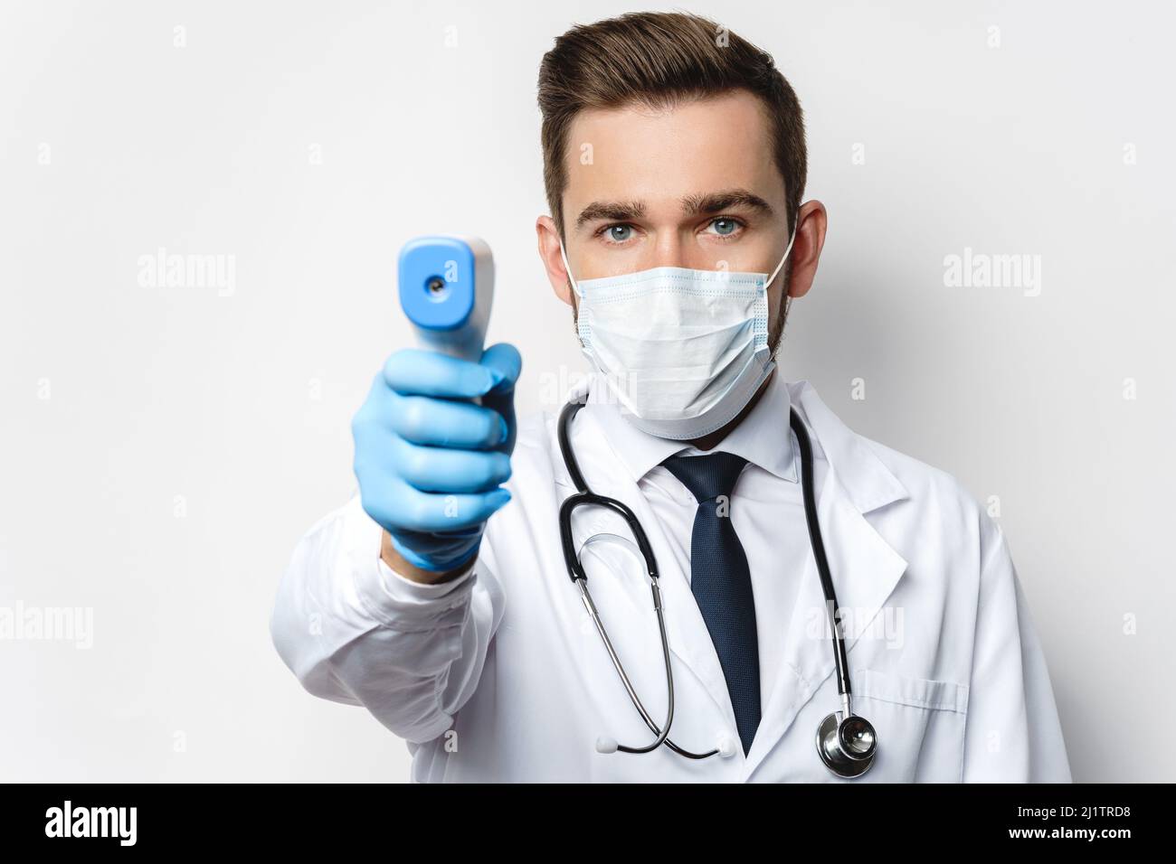 Doctor is measuring body temperature with a infrared thermometer Stock