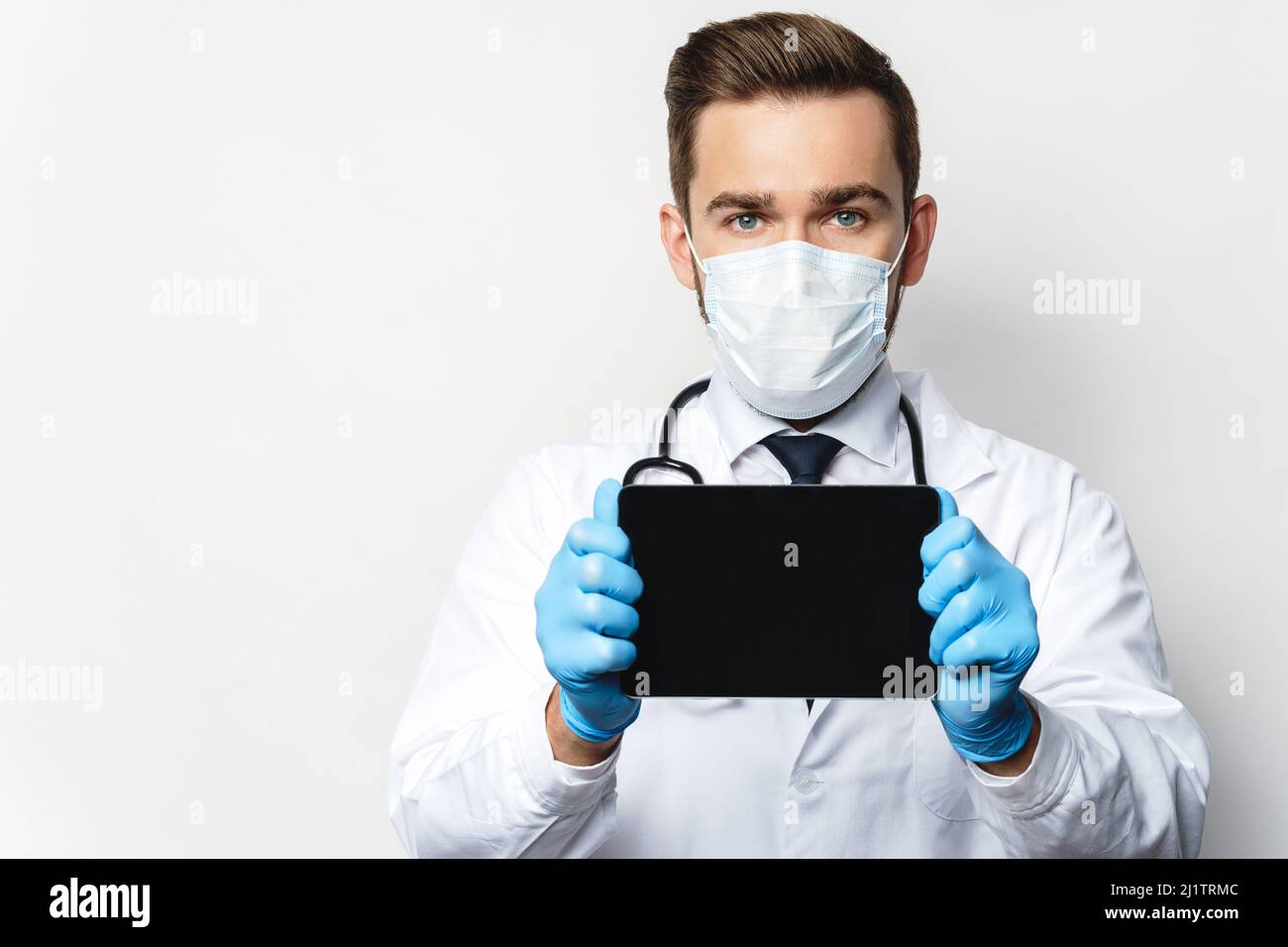 Young and confident doctor is using tablet pc Stock Photo