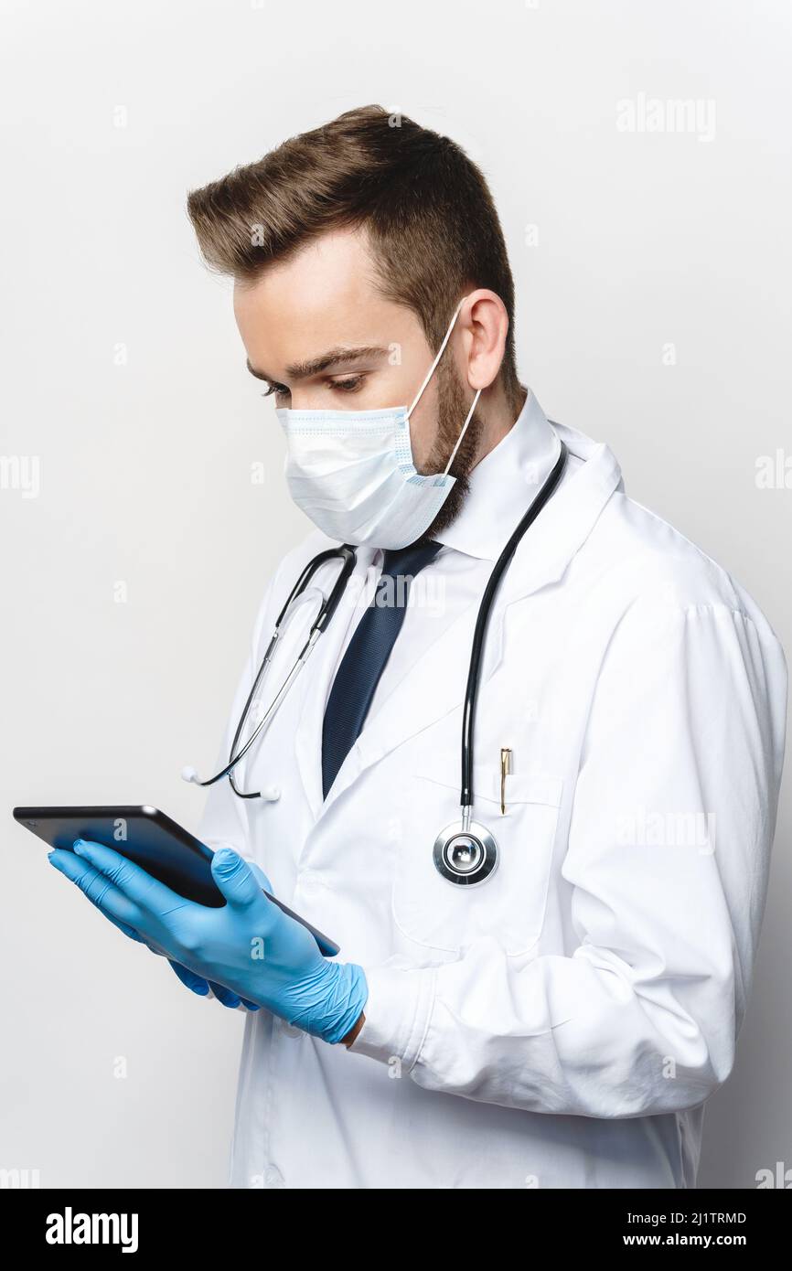 Young and confident doctor is using tablet pc Stock Photo