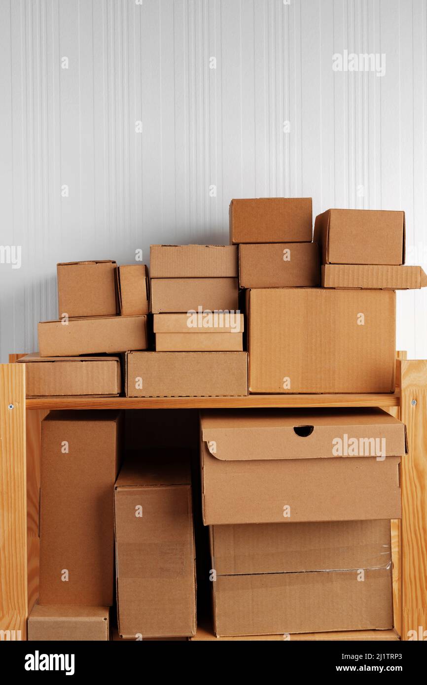Stack of cardboard package boxes on wooden rack Stock Photo - Alamy