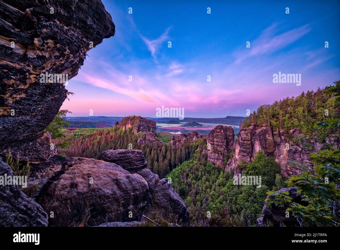 Landscape with rock formations and the summit Rauschenstein in Schmilka area of the Saxon Switzerland National Park at sunrise. Stock Photo