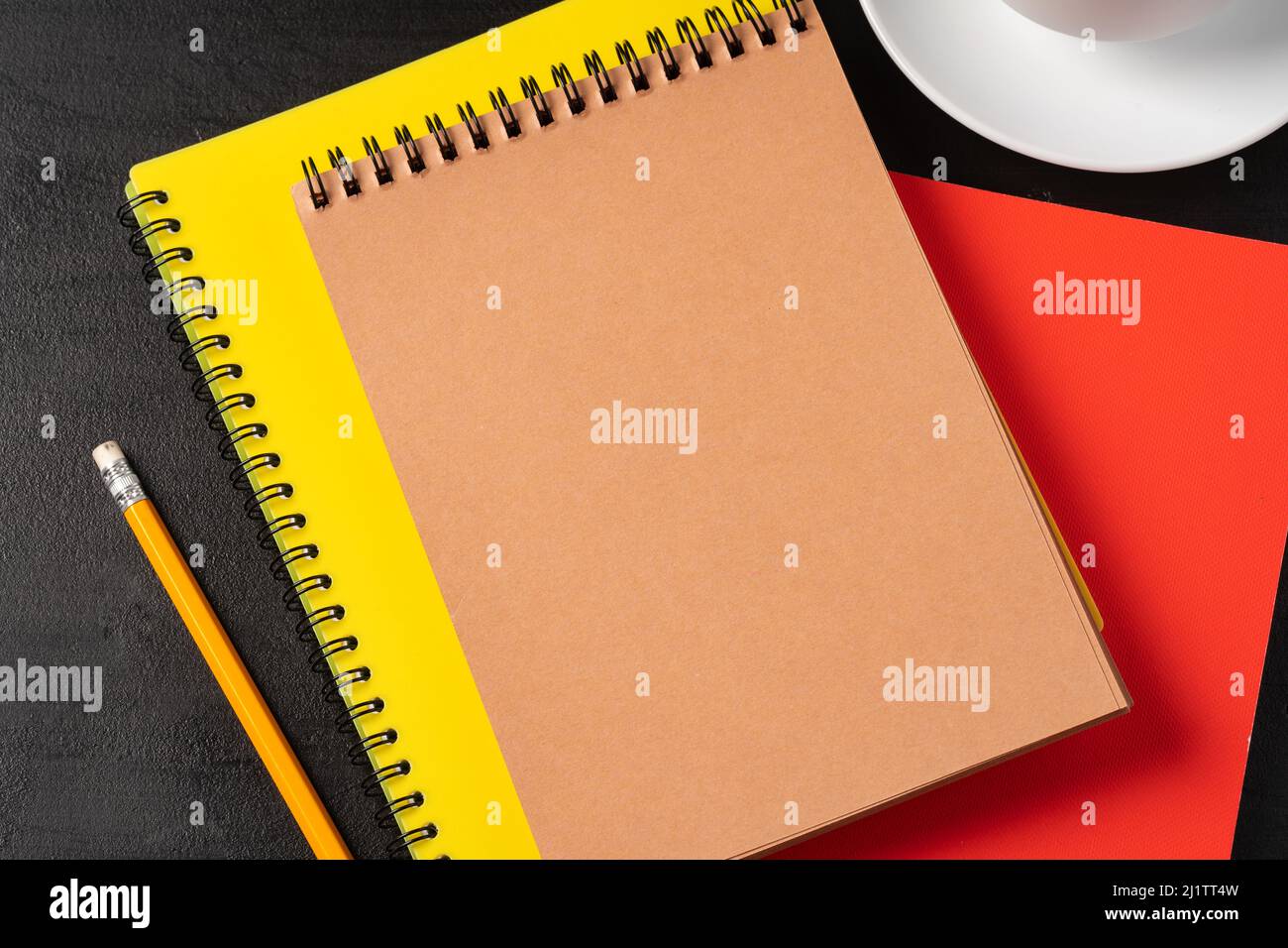 Three notepads on a black table close up Stock Photo