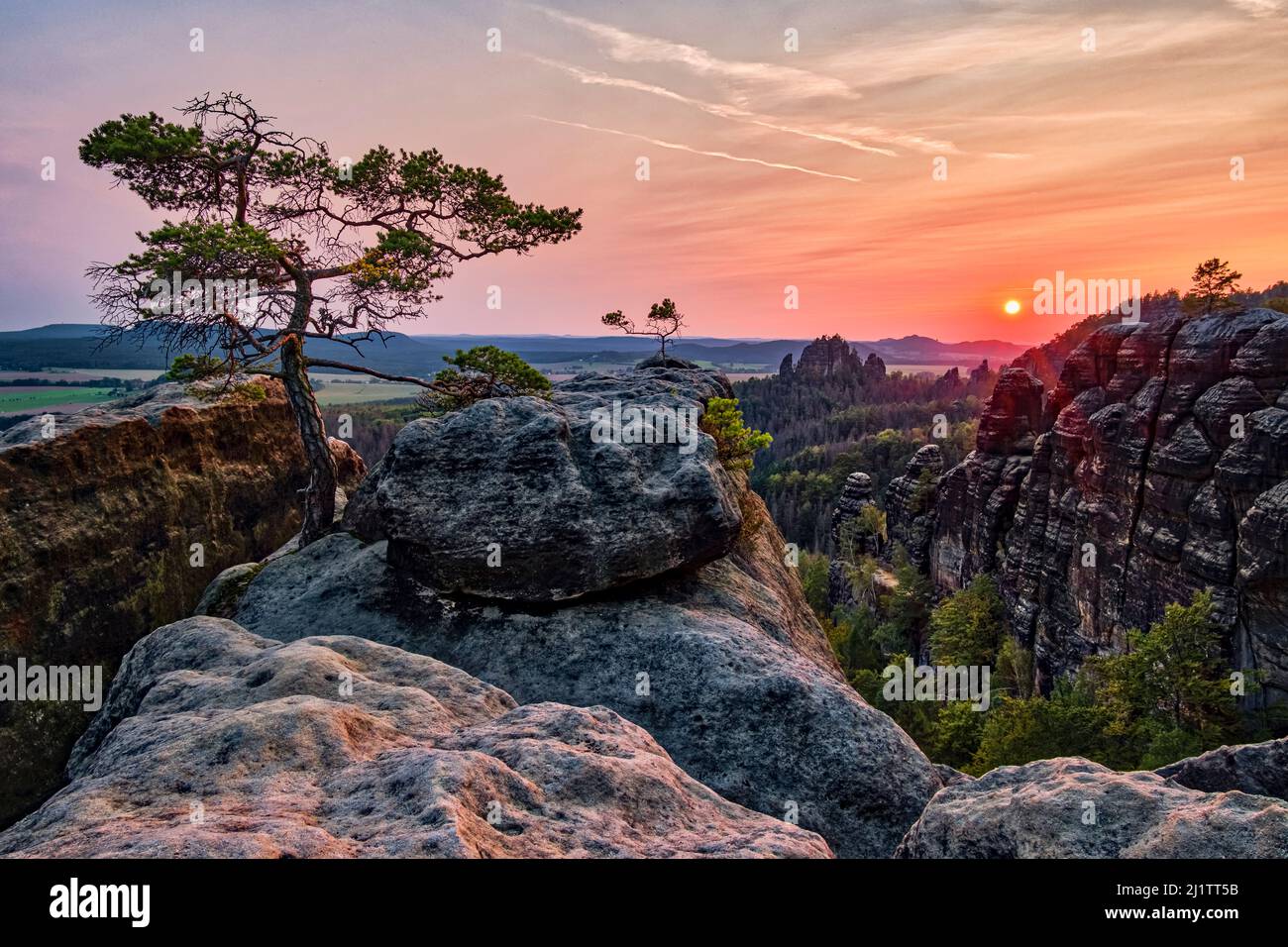 Landscape with rock formations and the summit Rauschenstein in Schmilka area of the Saxon Switzerland National Park at sunset. Stock Photo