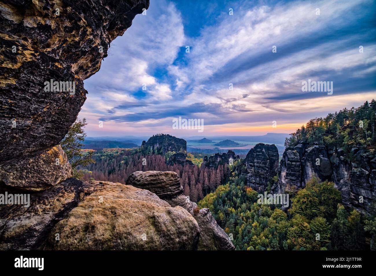 Landscape with rock formations and the summit Rauschenstein in Schmilka area of the Saxon Switzerland National Park at sunset. Stock Photo