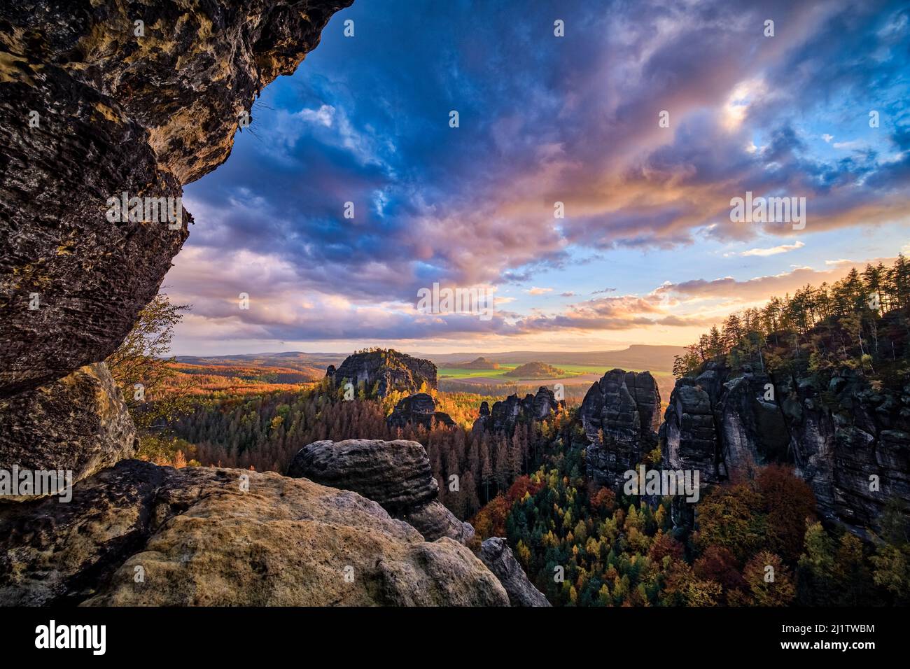 Landscape with rock formations, colorful trees and the summit Rauschenstein in Schmilka area of the Saxon Switzerland National Park in autumn. Stock Photo