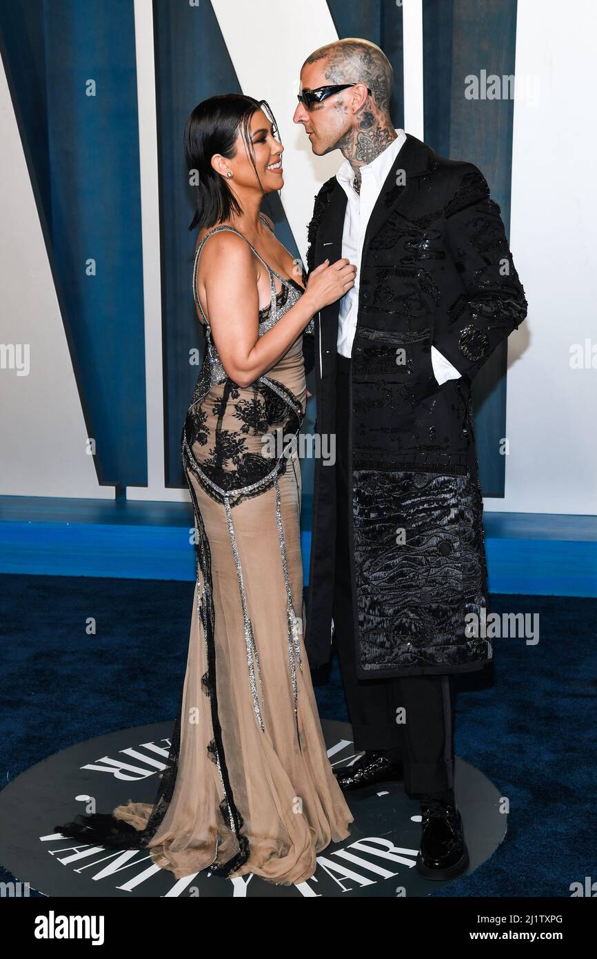 Kourtney Kardashian and Travis Barker walking on the red carpet at the