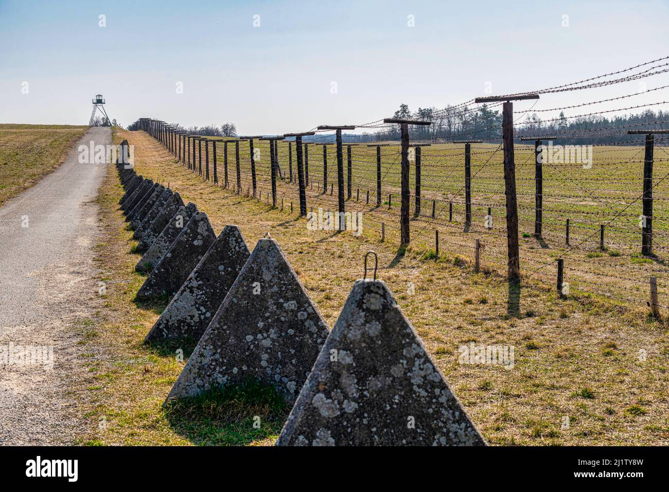 Memory of communism iron curtain in Cizov in Czech Republic village near Austrian Border with barb wireded fence, anti-tank obstacles and watchtower Stock Photo