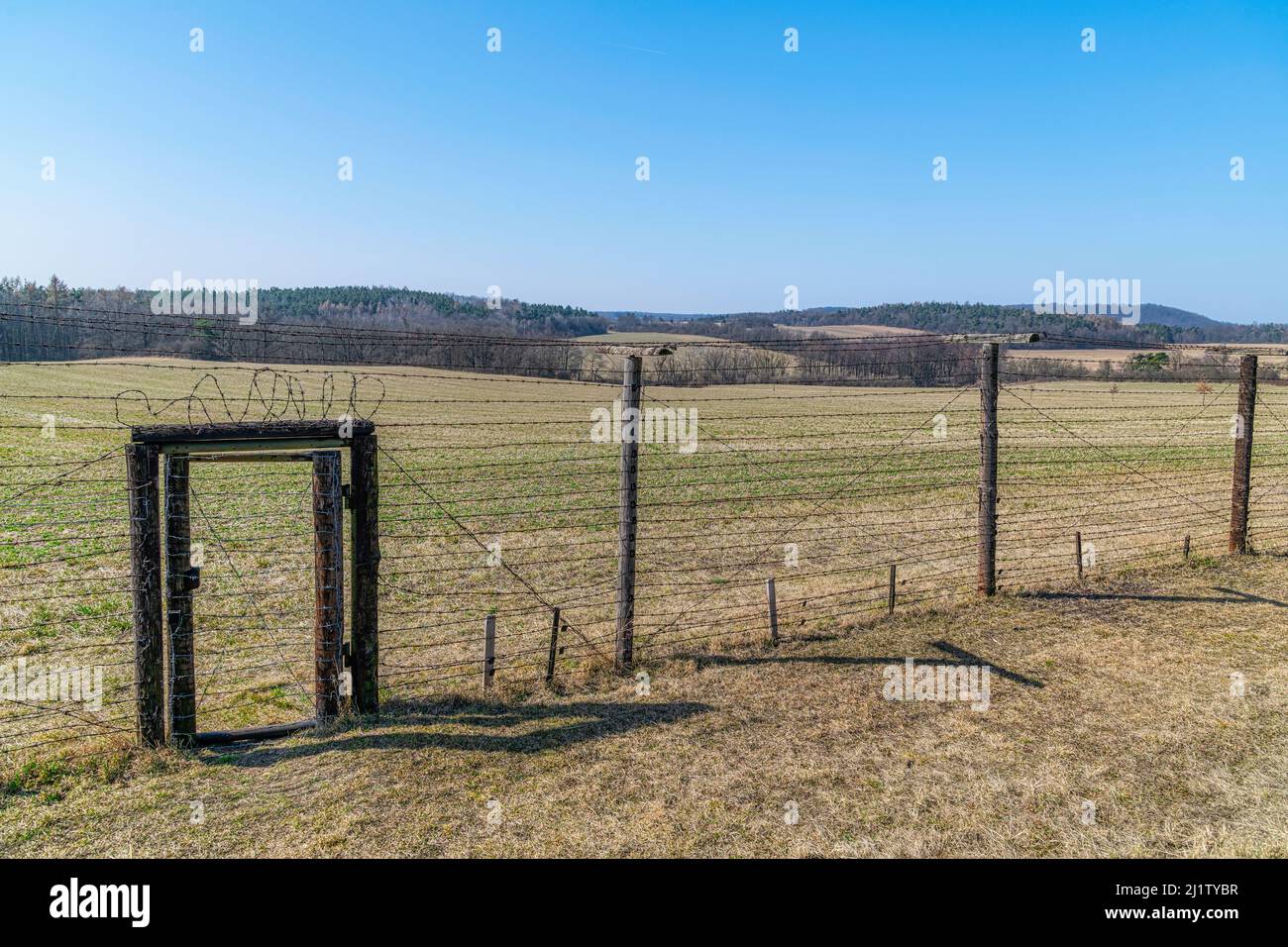 Memory of communism iron curtain in Cizov in Czech Republic village near Austrian Border with barb wireded fence, anti-tank obstacles and watchtower Stock Photo