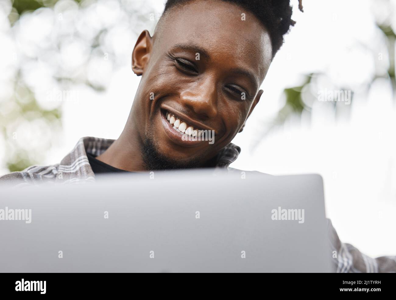 Dedicated and determined. Shot of a young man using a laptop on campus. Stock Photo