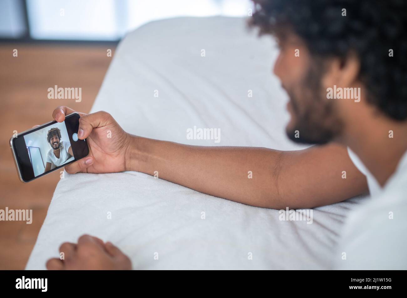 Male taking a selfie in the bedroom Stock Photo