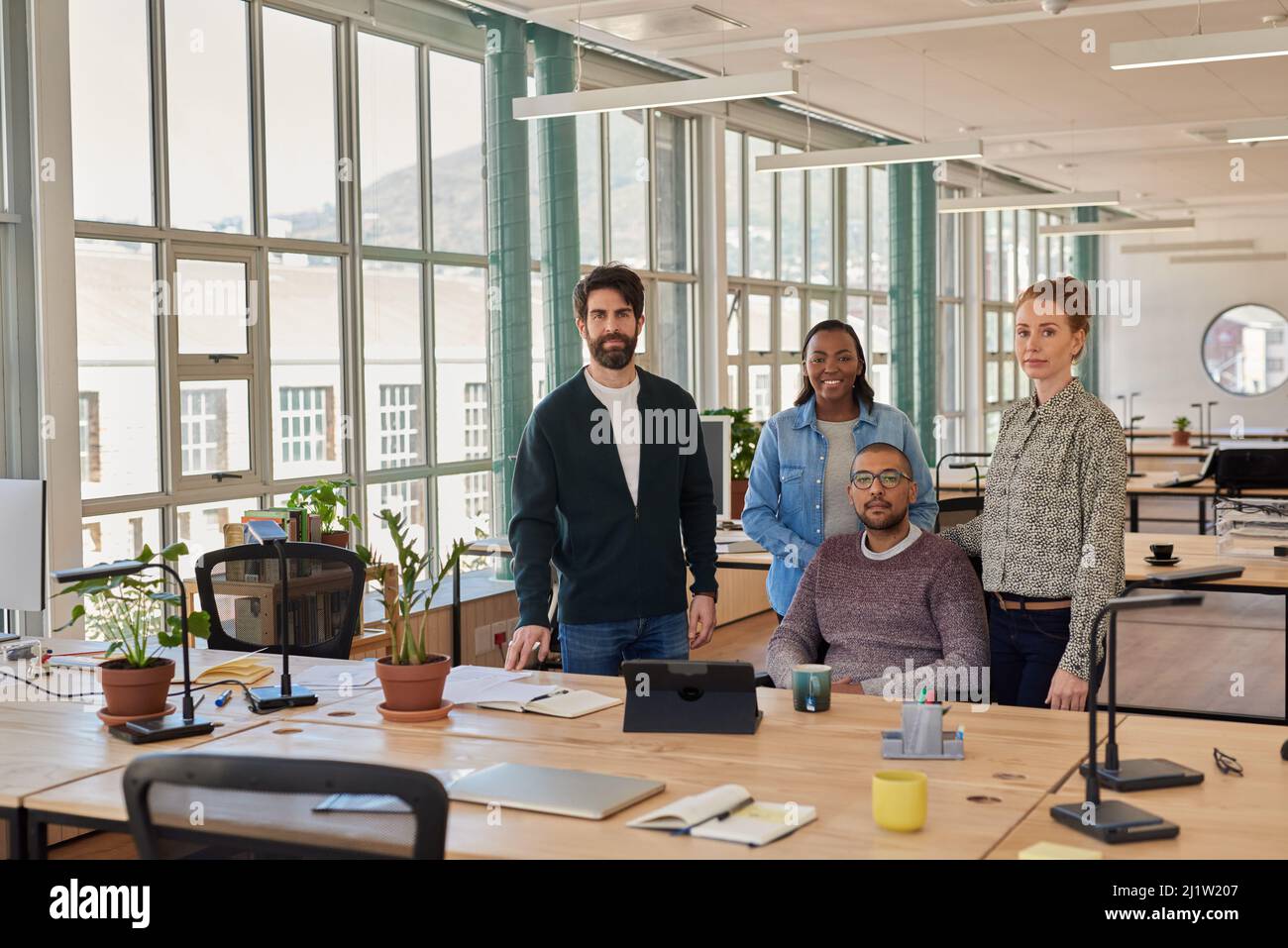 Confident group of young businesspeople working together in an office Stock Photo