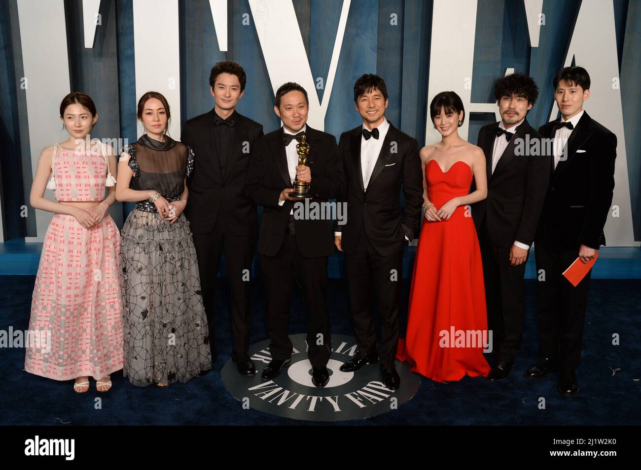 Japanese director Ryusuke Hamaguchi (centre) with the award for Best International Feature Film for 'Drive My Car', with the cast, attending the Vanity Fair Oscar Party held at the Wallis Annenberg Center for the Performing Arts in Beverly Hills, Los Angeles, California, USA. Picture date: Sunday March 27, 2022. Stock Photo