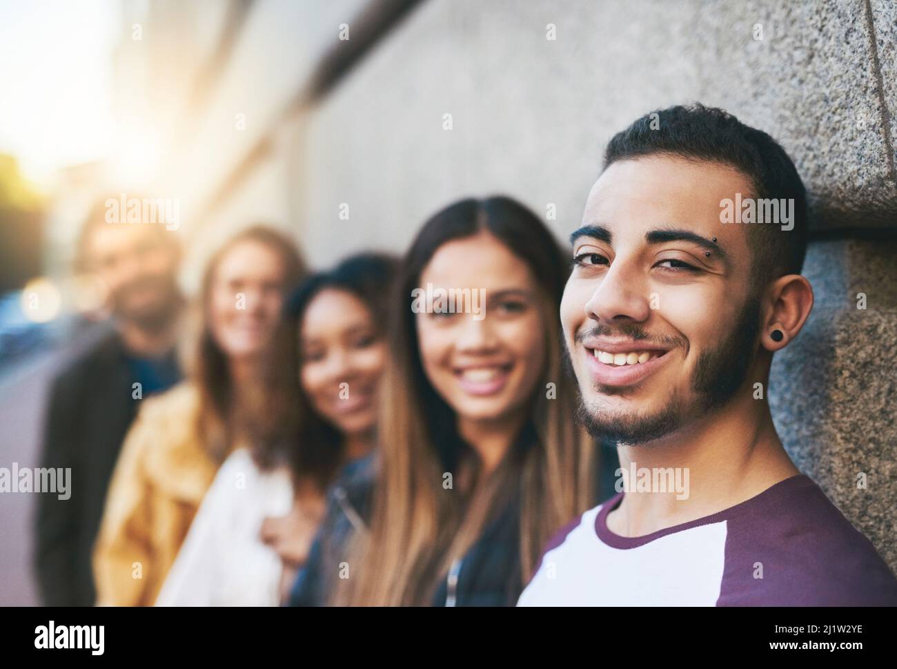 I like getting together with my friends. Cropped shot of friends standing together while out in the city. Stock Photo