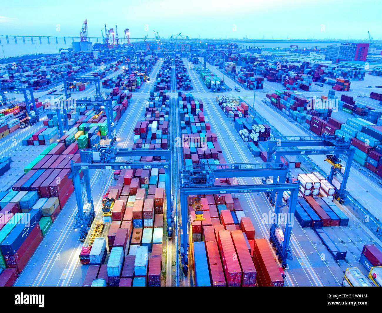 Nantong, Nantong, China. 28th Mar, 2022. On March 26, 2022, Nantong, Jiangsu, the container operation area of Gangtong sea port area. Tonghai Port Area is the first port area on the north bank after seagoing ships enter the 12.5-meter deep-water channel of the Yangtze River. It is also a modern container port area and a river-sea intermodal transport hub port built by Nantong City. According to Nantong Customs statistics, from January to February 2022, Nantong's foreign trade import and export value totaled 55.68 billion yuan, an increase of 23.5% over the same period last year, and foreign Stock Photo