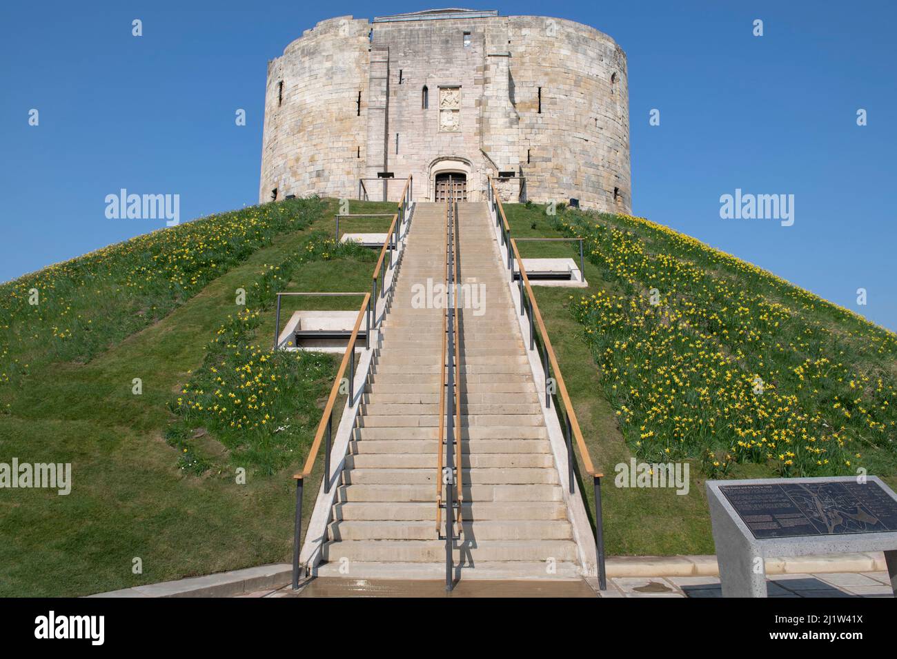 Clifford's Tower (York Castle) entrance in York surrounded by Daffodils in Spring. Stock Photo