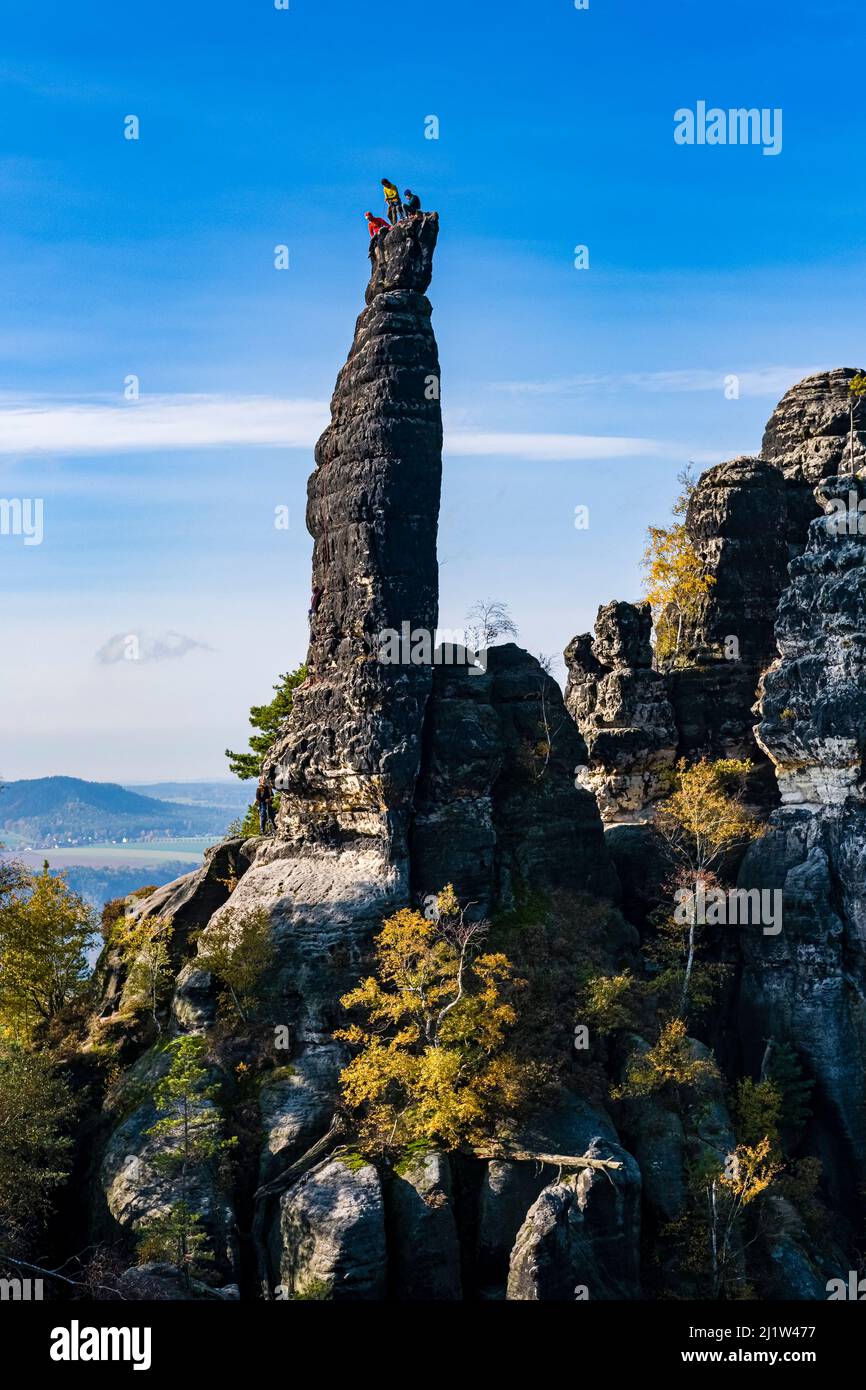 Climbers on the summit Tante in Schrammsteine area of the Saxon Switzerland National Park. Stock Photo