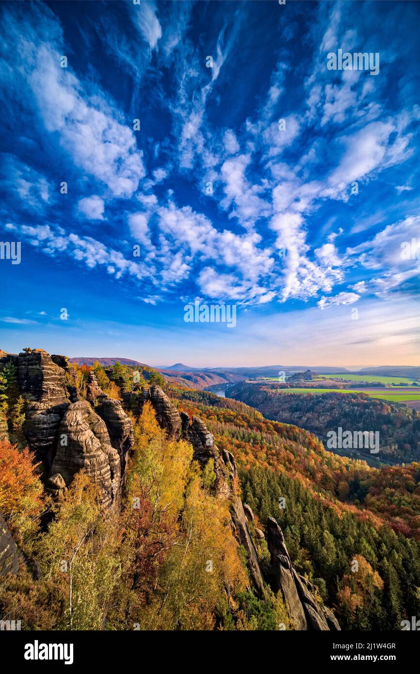 Landscape with rock formations, colorful trees and the Elbe valley in Schrammsteine area of the Saxon Switzerland National Park in autumn. Stock Photo