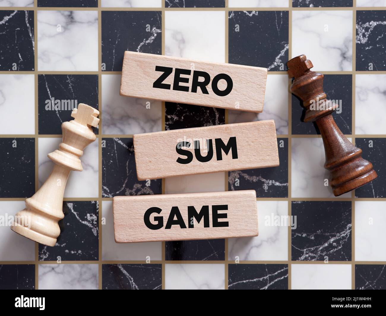 Two chess piece kings lying on the chessboard with the word zero sum