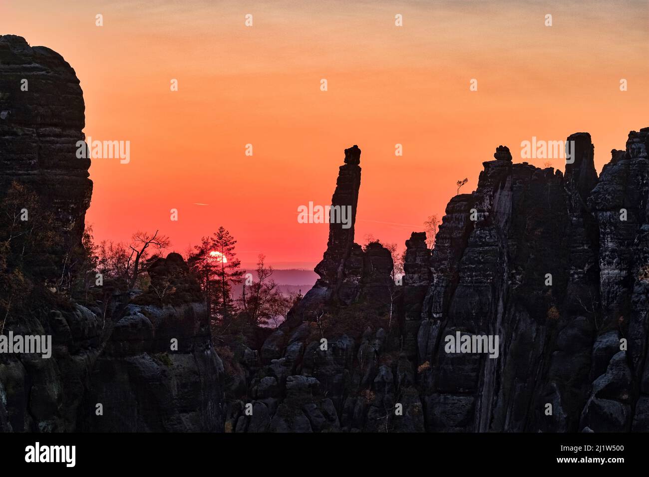 Landscape with rock formations and the summit Tante in Schrammsteine area of the Saxon Switzerland National Park at sunset. Stock Photo