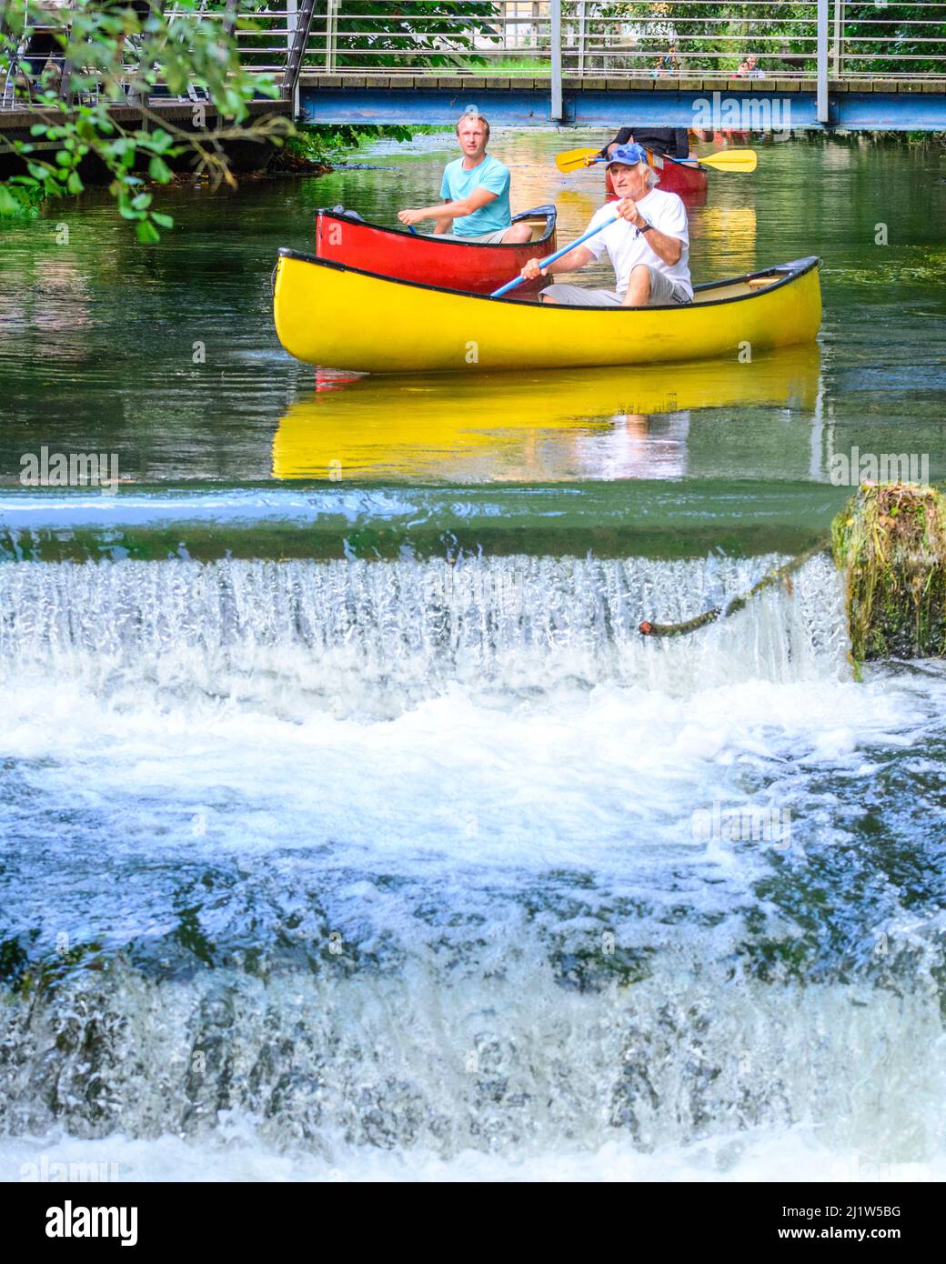 Experienced senior preparing for paddling down a weir Stock Photo
