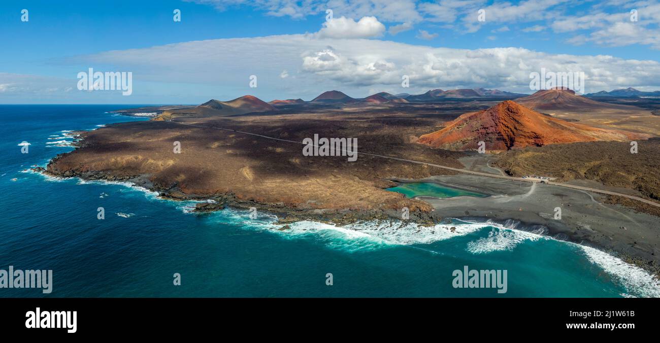 Charco Verde lake and volcan Bermeja on the island of Lanzarote, Spain Stock Photo