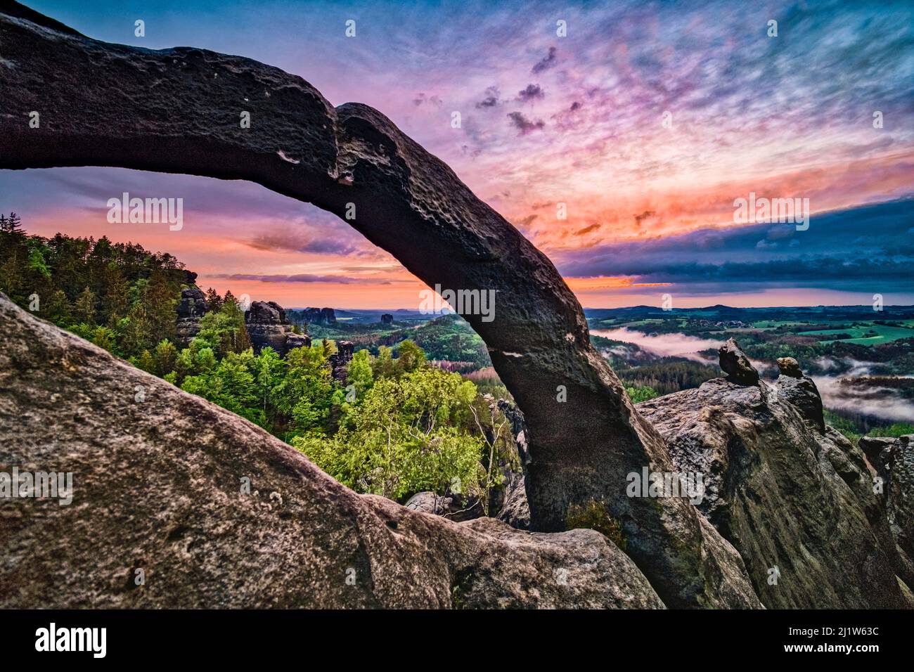 Landscape with rock formations in Affensteine area of the Saxon Switzerland National Park at sunset. Stock Photo